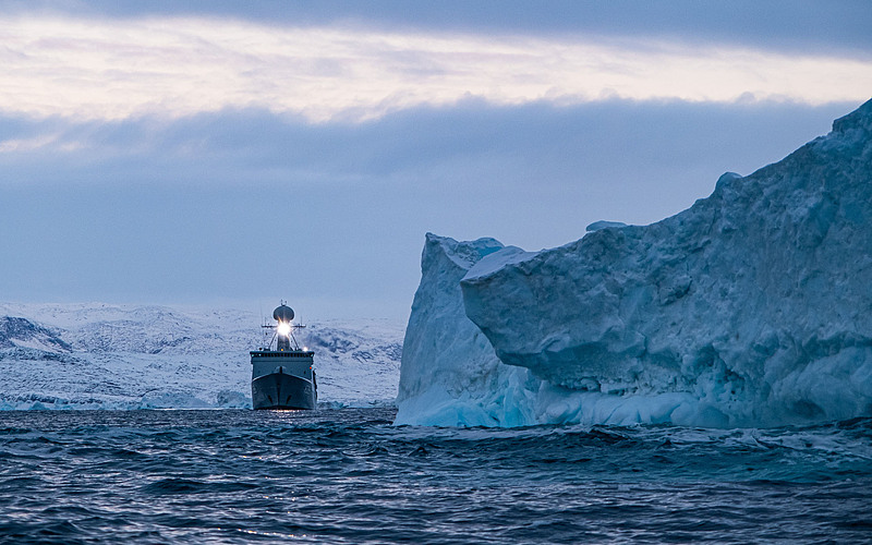 The Royal Danish Navy frigate HDMS Triton passes an iceberg in the waters around Greenland in 2022. /CFP