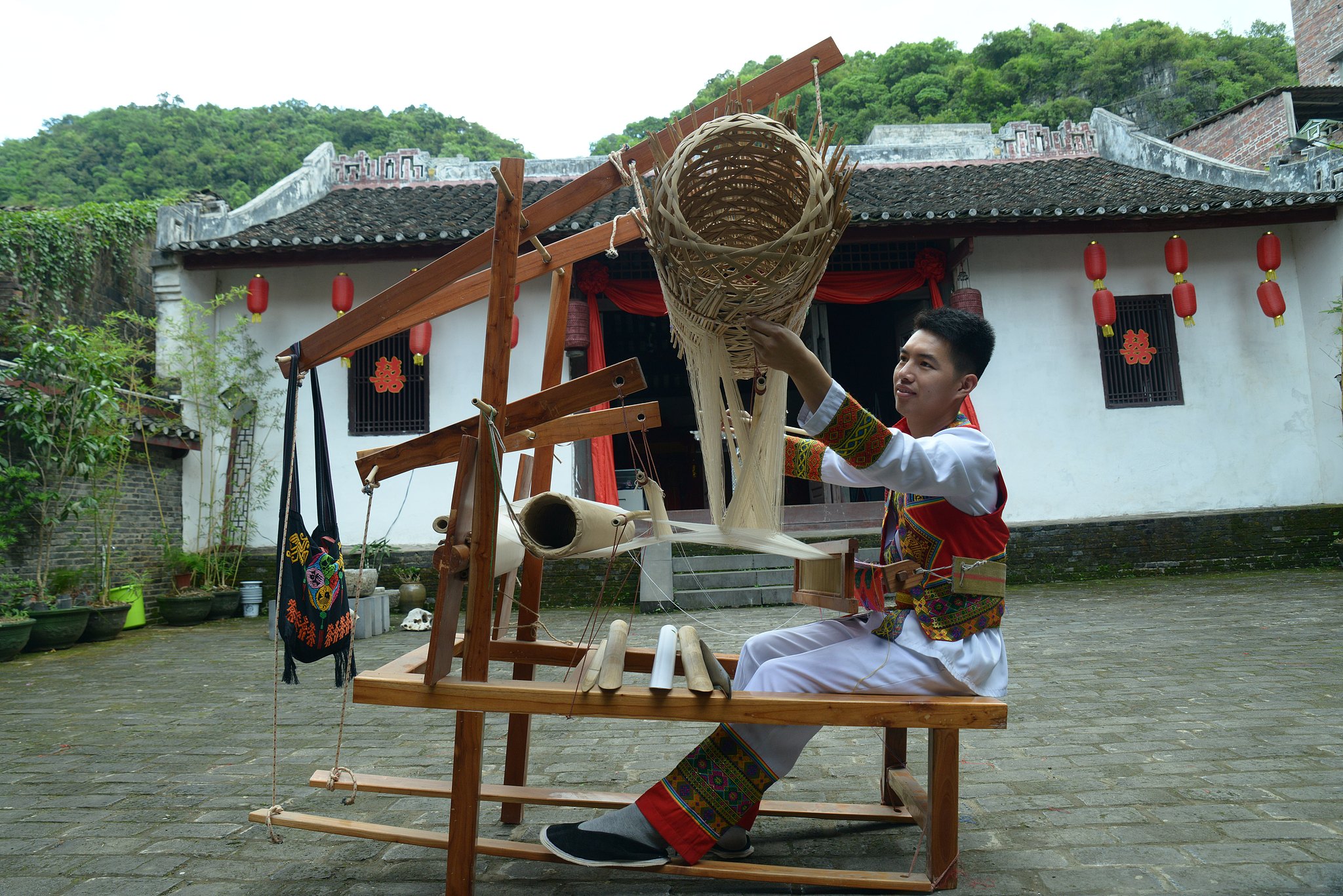 Liang Hengyuan, an inheritor of Zhuang brocade techniques, works at a studio in Xincheng County, Guangxi Zhuang Autonomous Region. /CFP