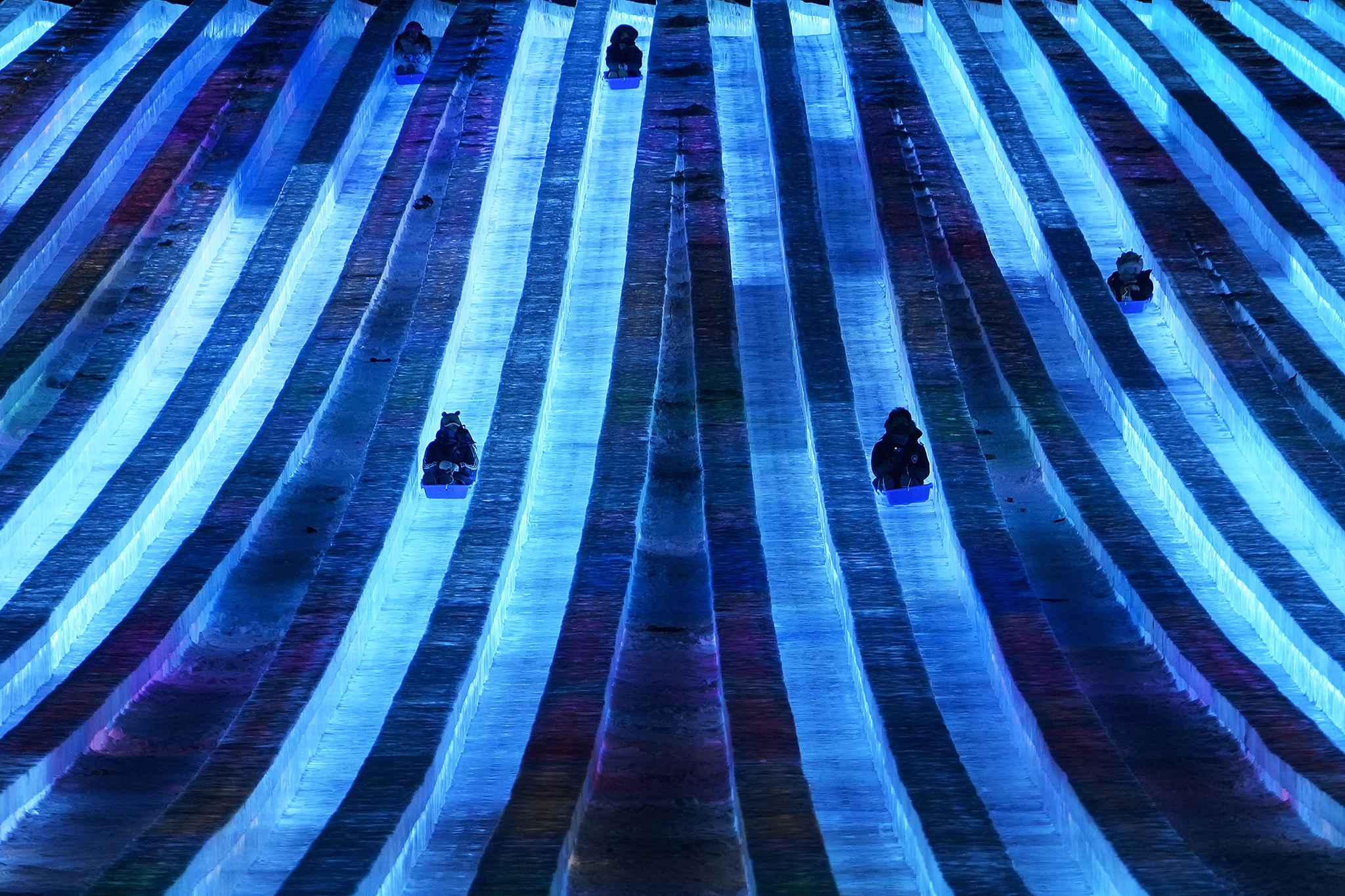 Visitors enjoy a slide built ice blocks during the opening ceremony of the Ice and Snow World in Harbin, Heilongjiang Province, China, January 5, 2025. /CFP