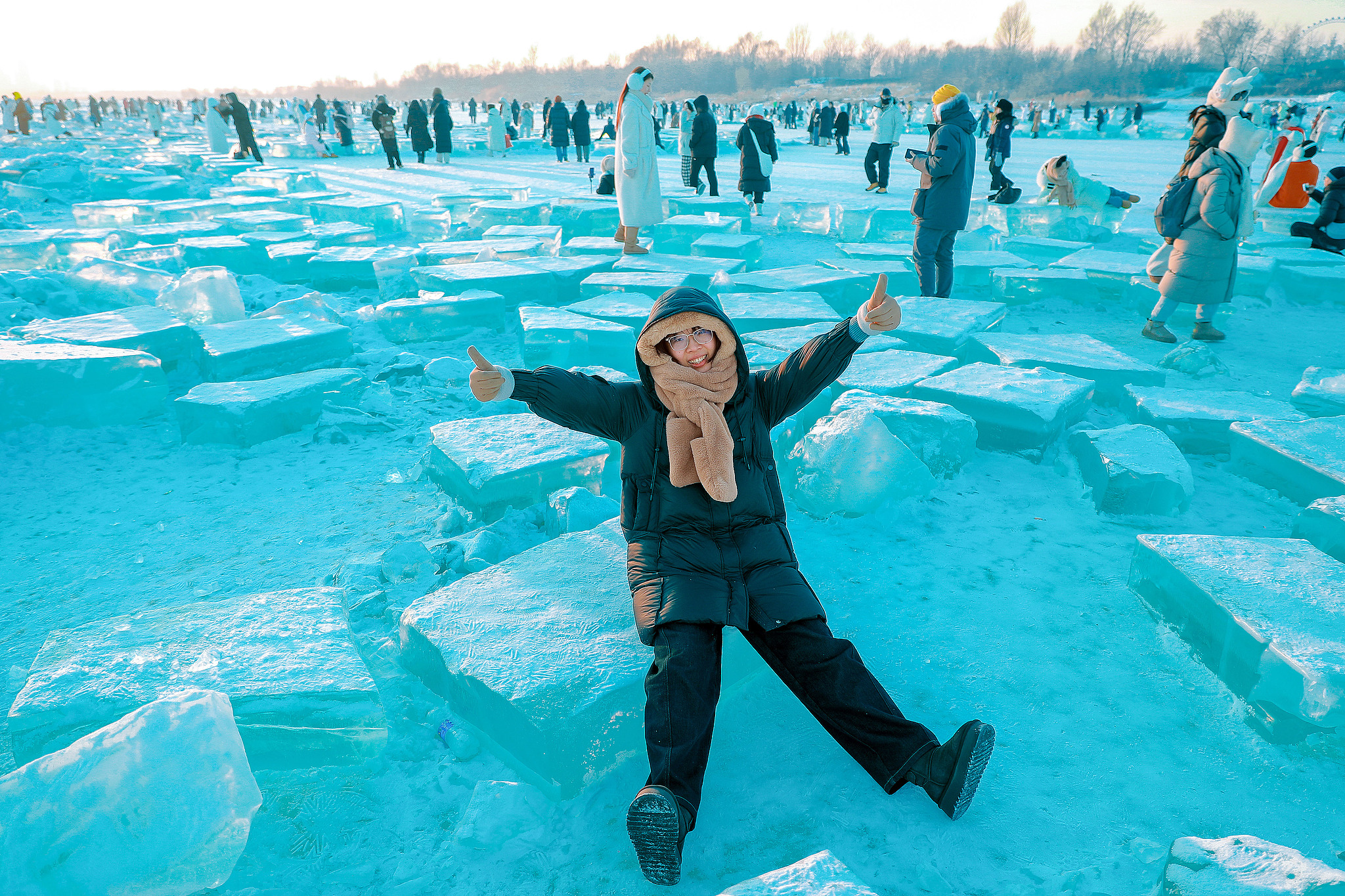 A tourist poses for photos on the frozen surface of the Songhua River in Harbin, Heilongjiang Province, China, January 4, 2025. /CFP