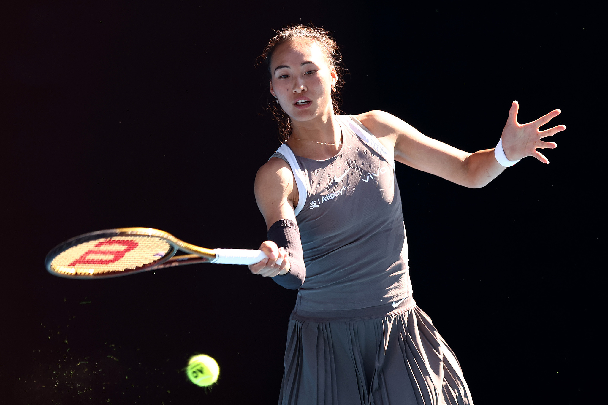 Zheng Qinwen of China hits a shot in the charity exhibition match against Elina Svitolina of Ukraine at Rod Laver Arena in Melbourne, Australia, January 8, 2025. /CFP