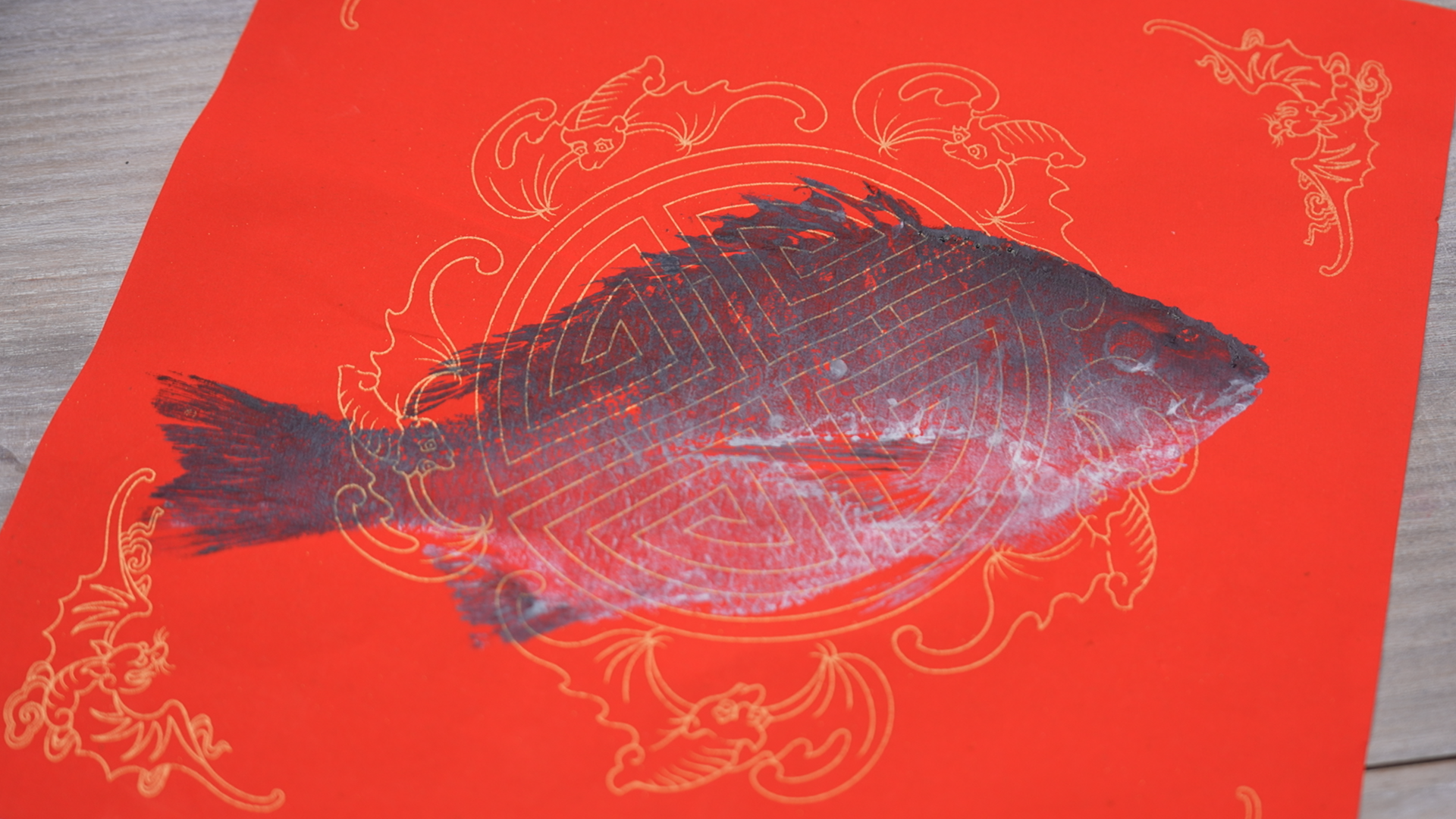 Fish print on a red paper by Lu, Xiangshan, December 27, 2024. /CGTN