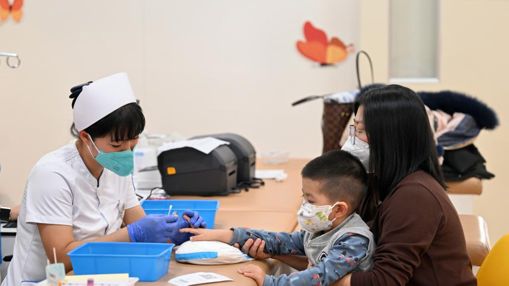 A nurse collects blood for a child at a children's outpatient department of a hospital in Changchun, northeast China's Jilin Province, November 24, 2023. /Xinhua