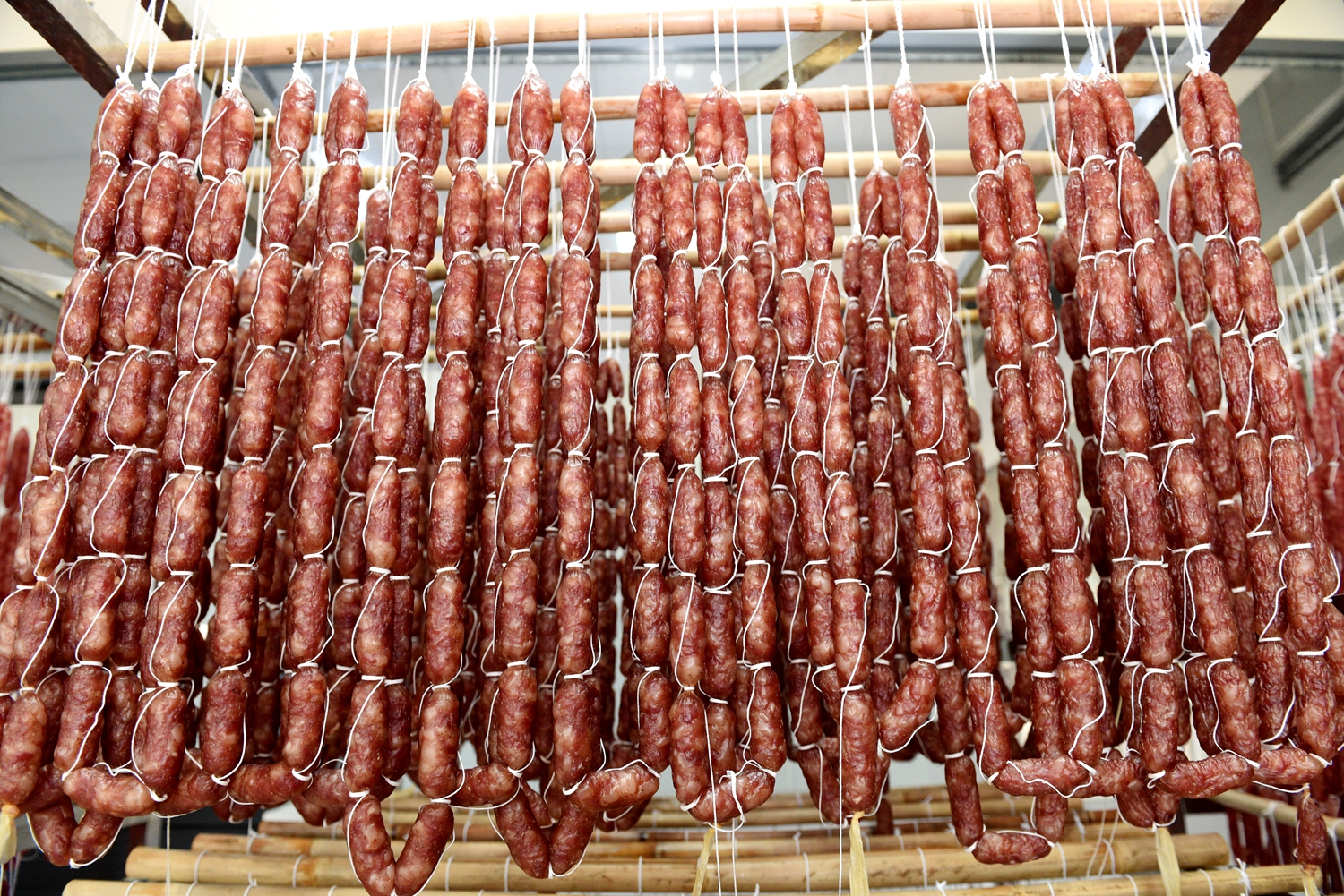 Cured sausages are prepared at a food factory in Tunchang, Hainan Province on January 6, 2025. /Photo provided to CGTN