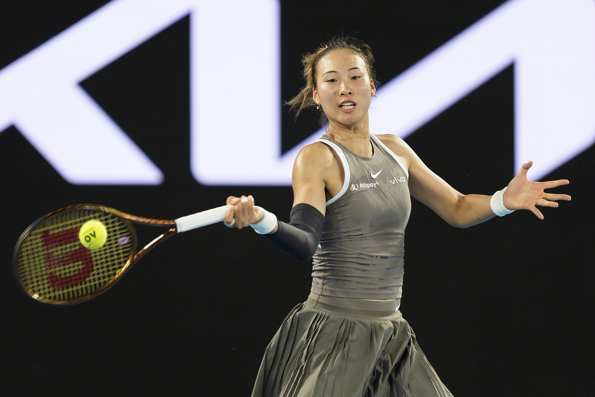 Zheng Qinwen of China hits a shot in the women's singles first-round match against Anca Todoni of Romania at Melbourne Park in Melbourne, Autralia, January 11, 2025. /CFP