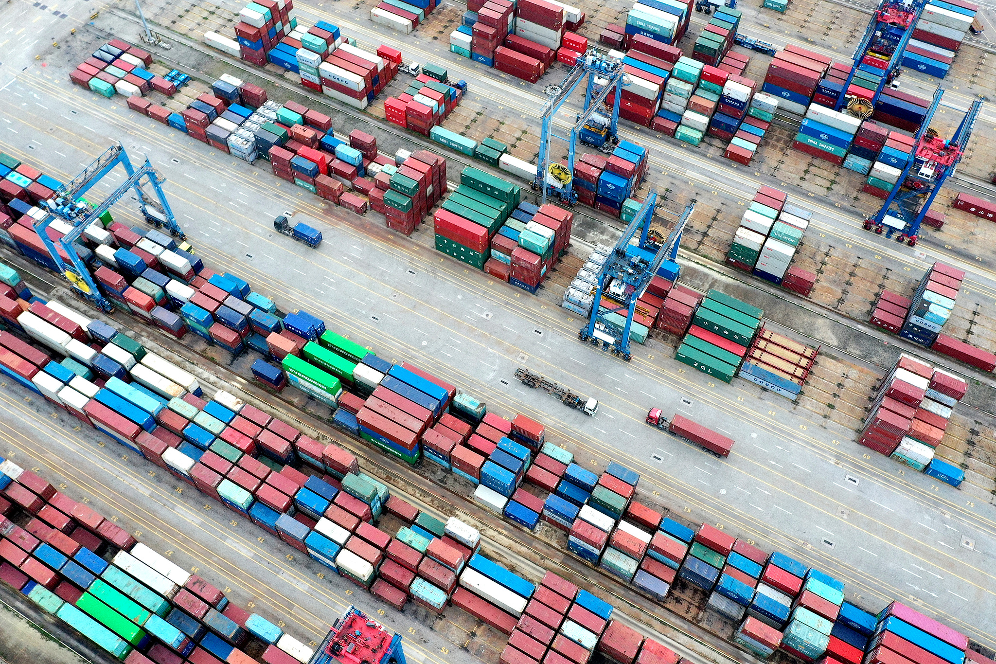 Transport vehicles shuttling back and forth at a dock in Quanzhou, Fujian Province on June 9, 2024. /CFP