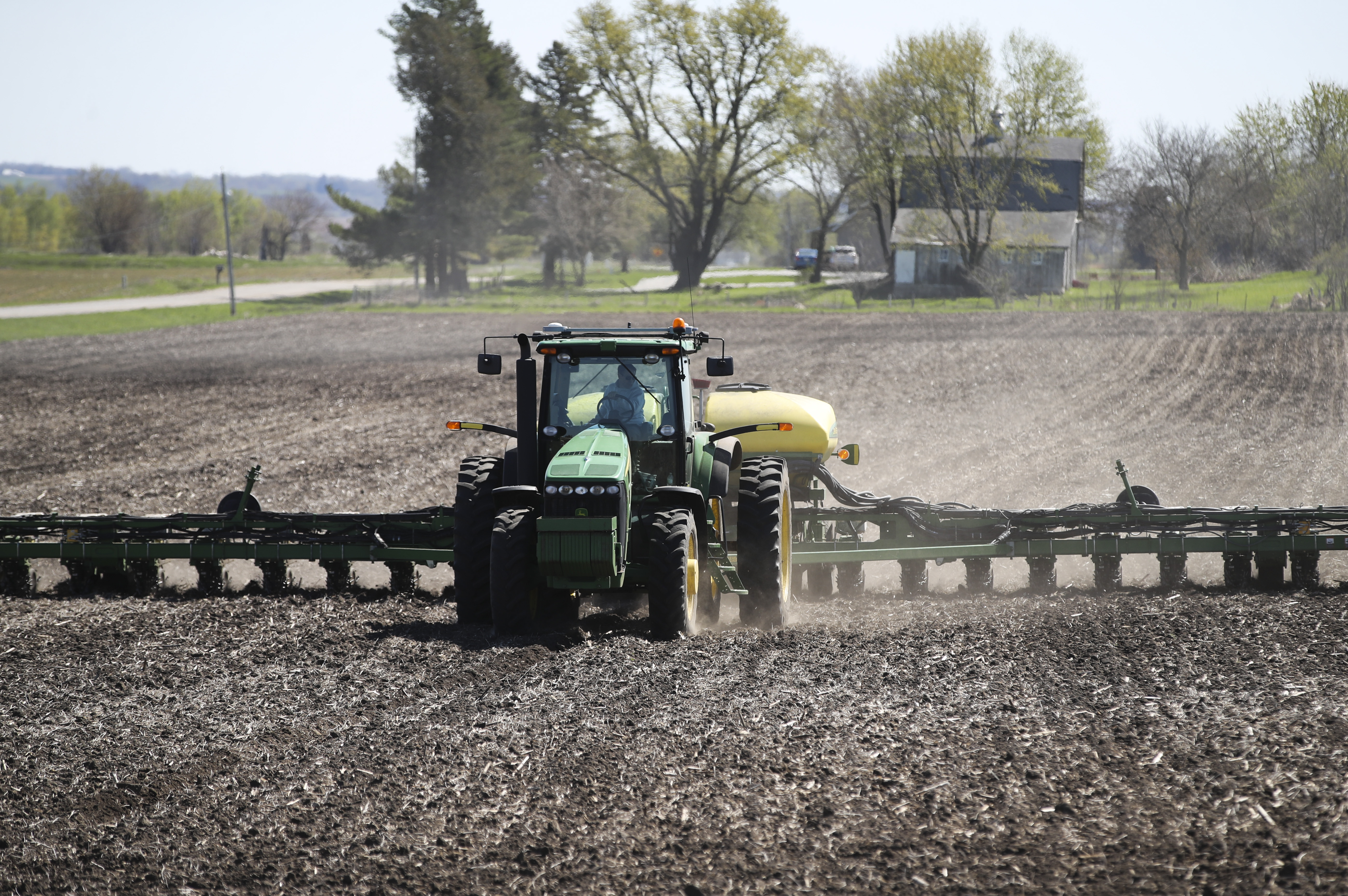 An American soybean farmer operates a seeding machine at his family farm in Maxwell, Iowa, the United States, April 26, 2019. /Xinhua