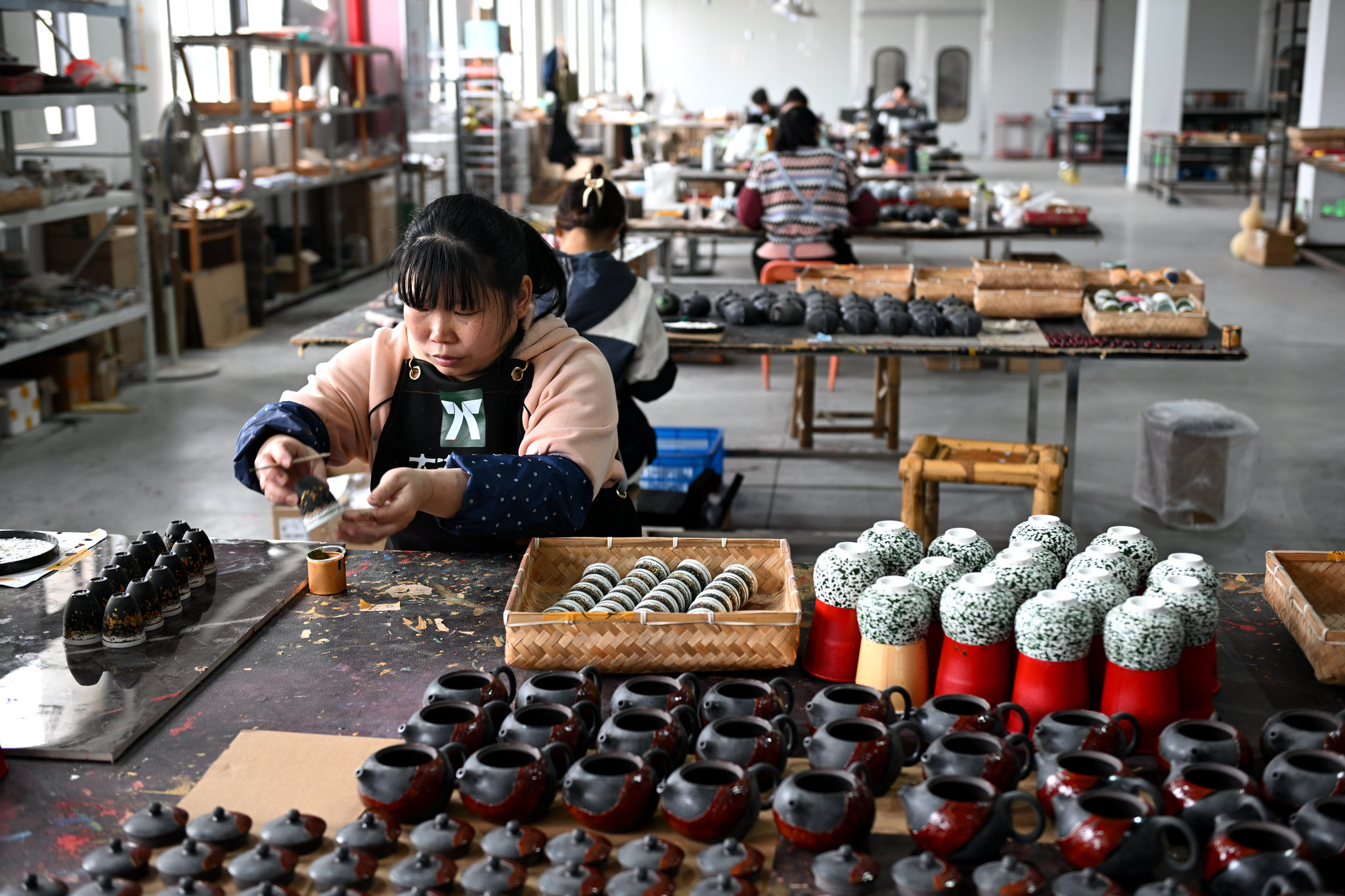 Lacquer artists work on bringing vibrant creations to life at a workshop in Fuzhou, Fujian Province, March 13, 2025. /VCG
