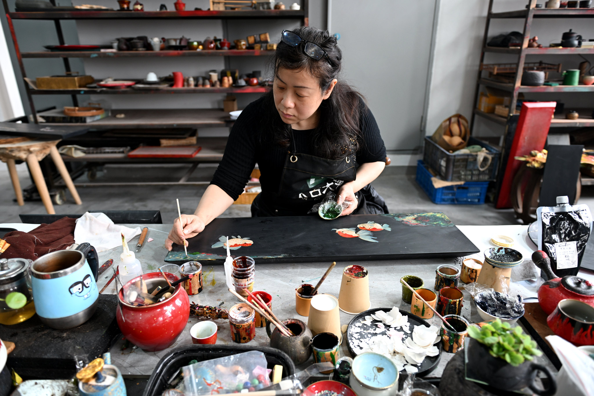 Lacquer artists work on bringing vibrant creations to life at a workshop in Fuzhou, Fujian Province, March 13, 2025. /VCG
