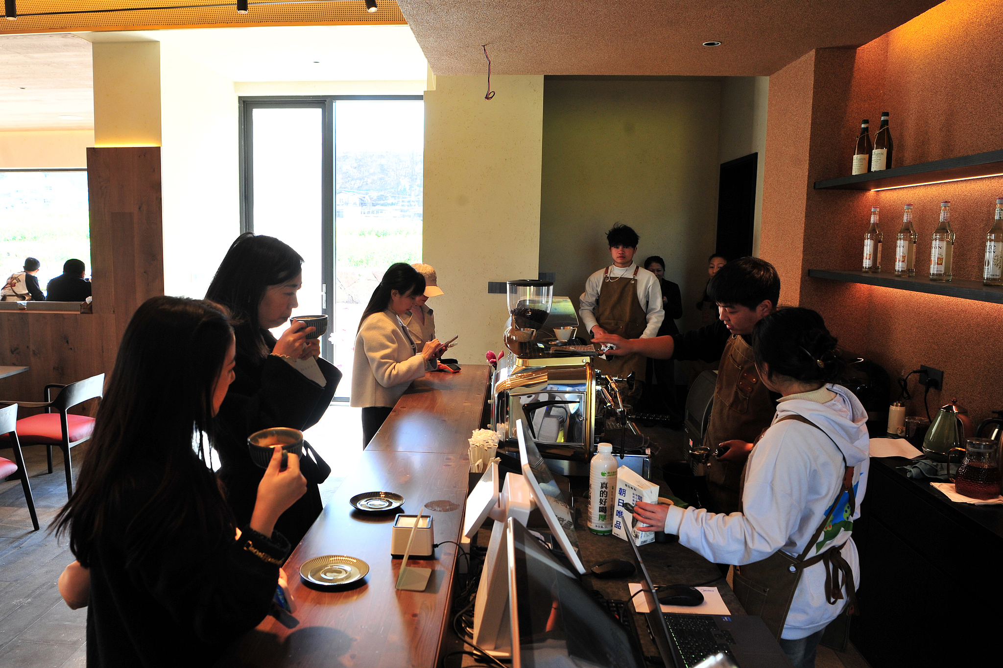 People enjoy coffee at a cafe in Nanya Village in Yichang, Hubei Province on March 18, 2025. /VCG
