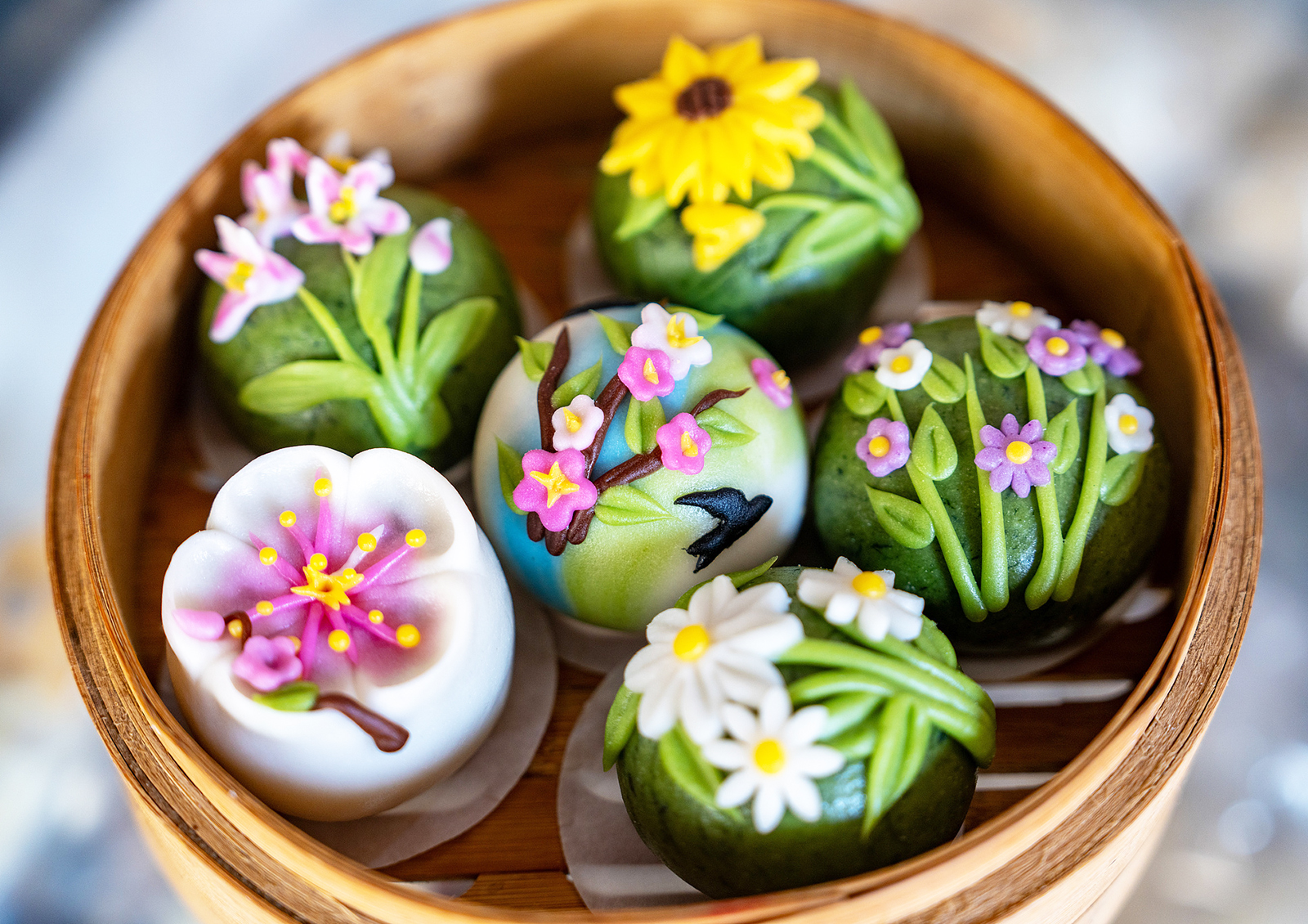 Qingming rice cakes featuring vibrant designs are seen at a workshop in Jinhua, Zhejiang Province on March 18, 2025. /VCG