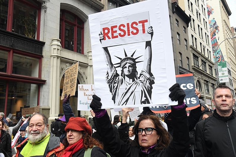 Protestors all came out in inclement weather to protest U.S. President Donald Trump's tariff, immigration, federal job cutting and budget cutting policies in New York, April 5, 2025. /CFP 