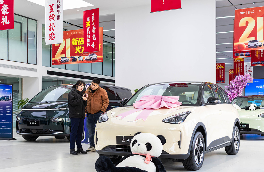 Customers compare new energy vehicles at a showroom in Hohhot, north China's Inner Mongolia Autonomous Region, March 5, 2025. /VCG