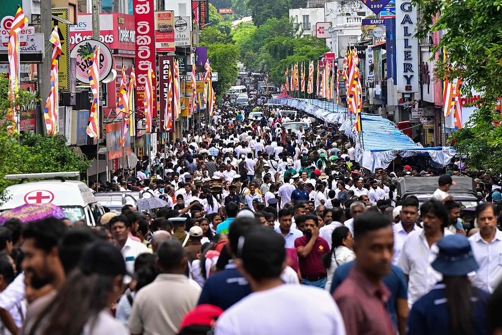 Buddhist devotees stand in queues waiting to enter the Temple of the Tooth, a public exhibition of the Sacred Tooth Relic of the Buddha in Kandy, Sri Lanka, on April 27, 2025. /CFP