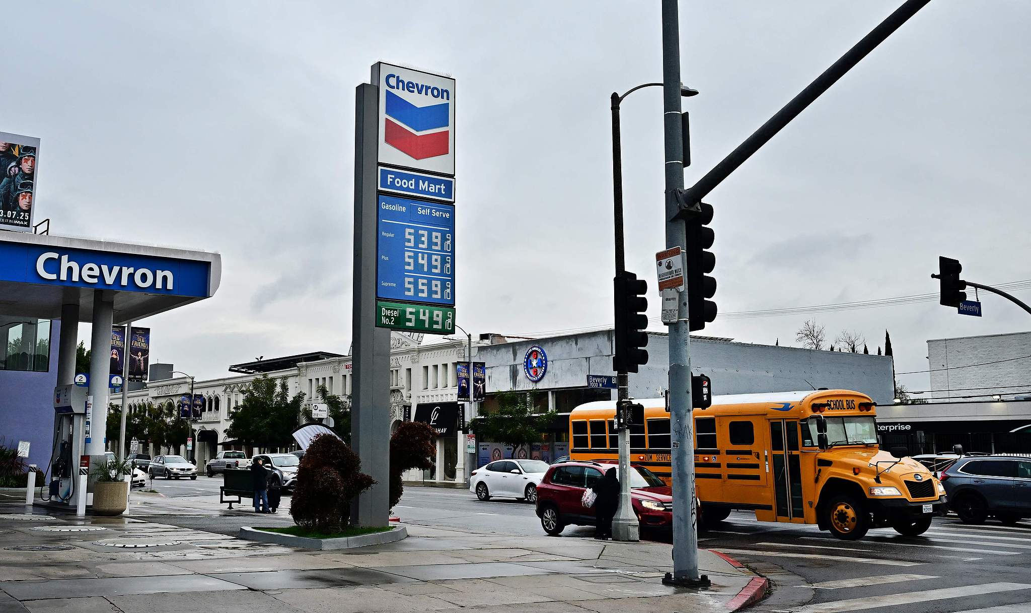 A school bus passes a petrol station in Los Angeles, California, the U.S., February 12, 2025. /CFP