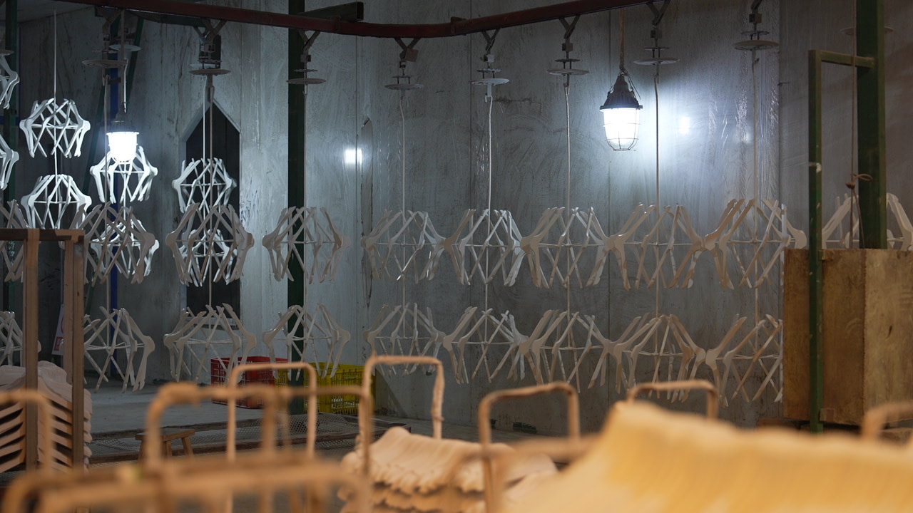 Hangers lined up for spray-painting at a factory in Lipu City, May 15, 2025. /CGTN