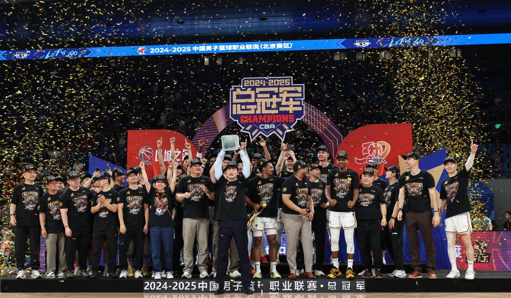 Players and coaches of the Guangsha Lions celebrate winning the team's first Chinese Basketball Association (CBA) championship after defeating the Beijing Ducks 4-2 in the CBA Finals in Beijing, May 20, 2025. /Xinhua