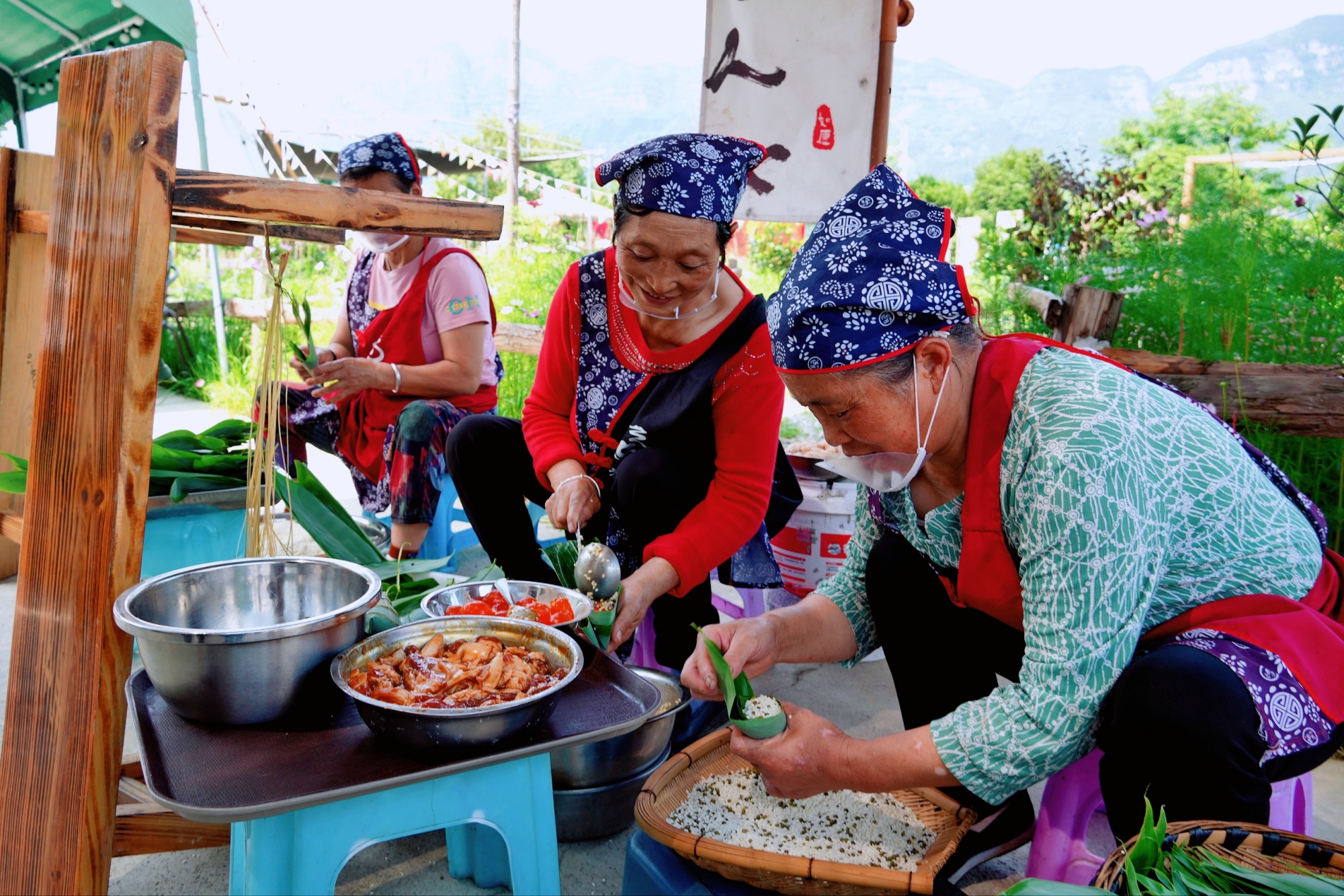 People make traditional zongzi in Sinan County, southwest China's Guizhou Province, on May 20, 2025. /Photo provided to CGTN