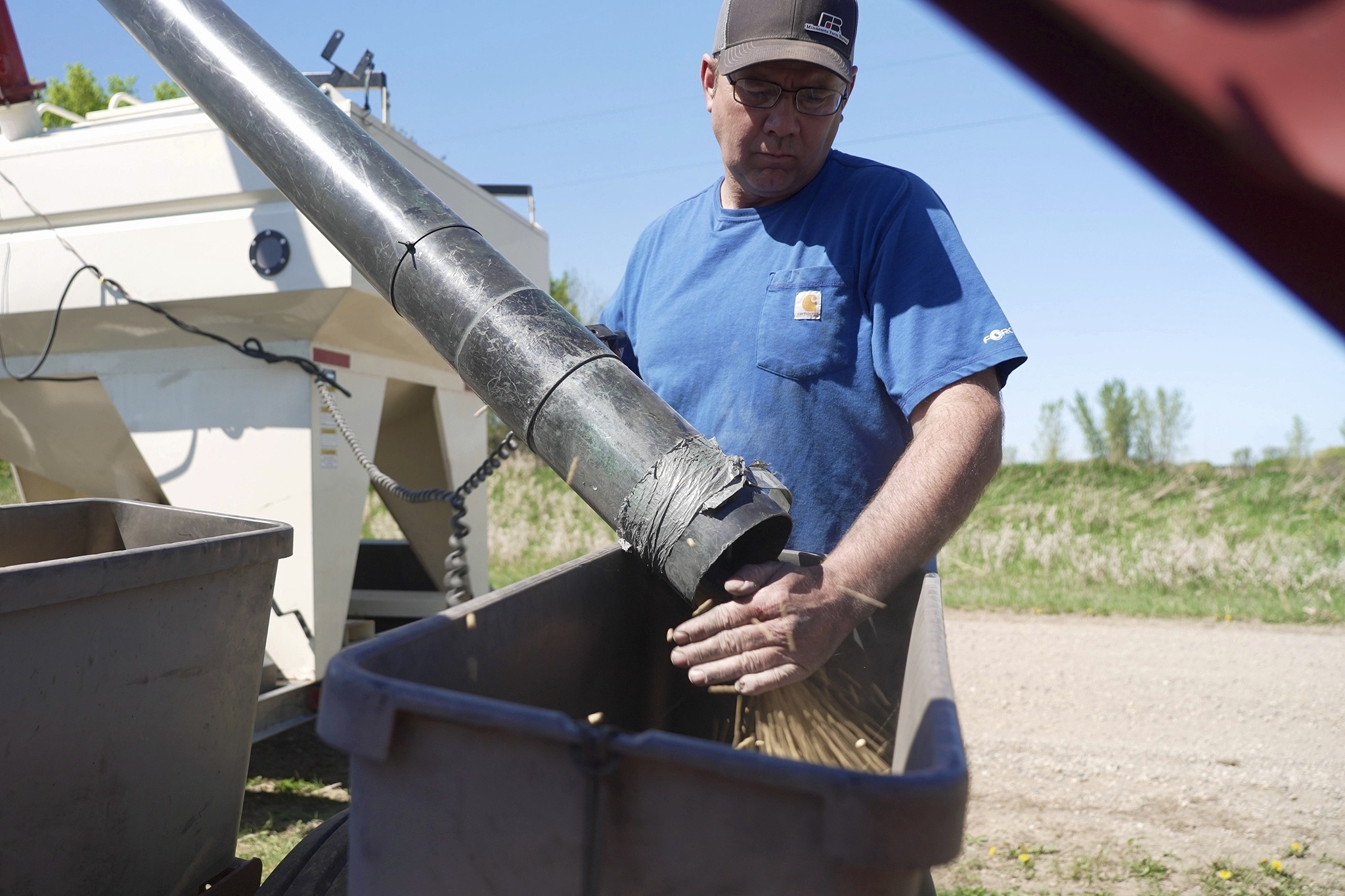 Minnesota Farm Bureau president Dan Glessing loads soybeans into his planter on Thursday, May 8, 2025 near Waverly, Minn. / VCG