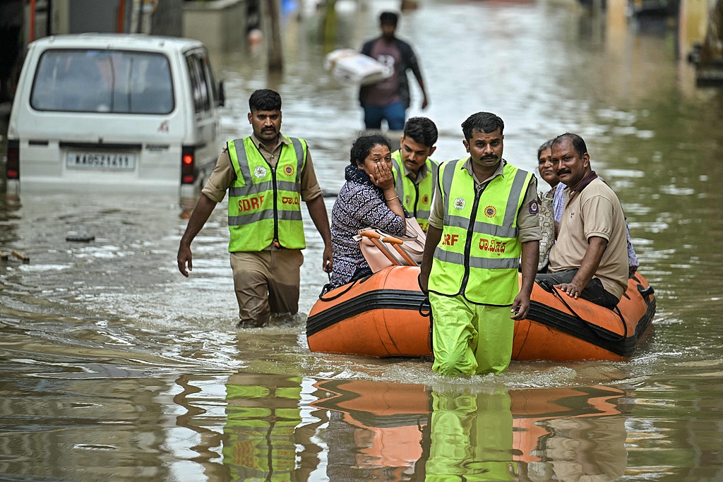 State Disaster Response Force personnel rescue residents from a flooded area following heavy rainfall in Bengaluru, May 19, 2025. /CFP