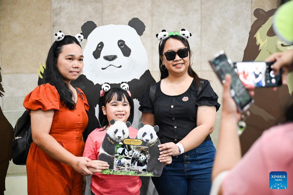 People bidding farewell to panda pair Xing Xing and Liang Liang pose for photos at Zoo Negara near Kuala Lumpur, Malaysia, May 17, 2025. /Xinhua