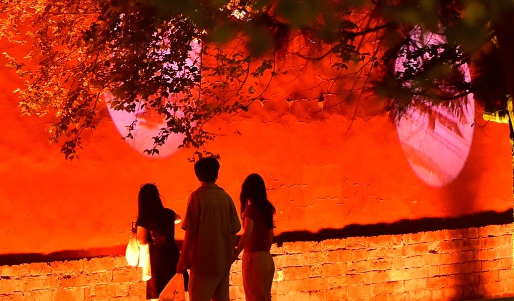 Projections are cast onto the red walls of the Shenyang Palace in Liaoning Province on June 16, 2025. /IC