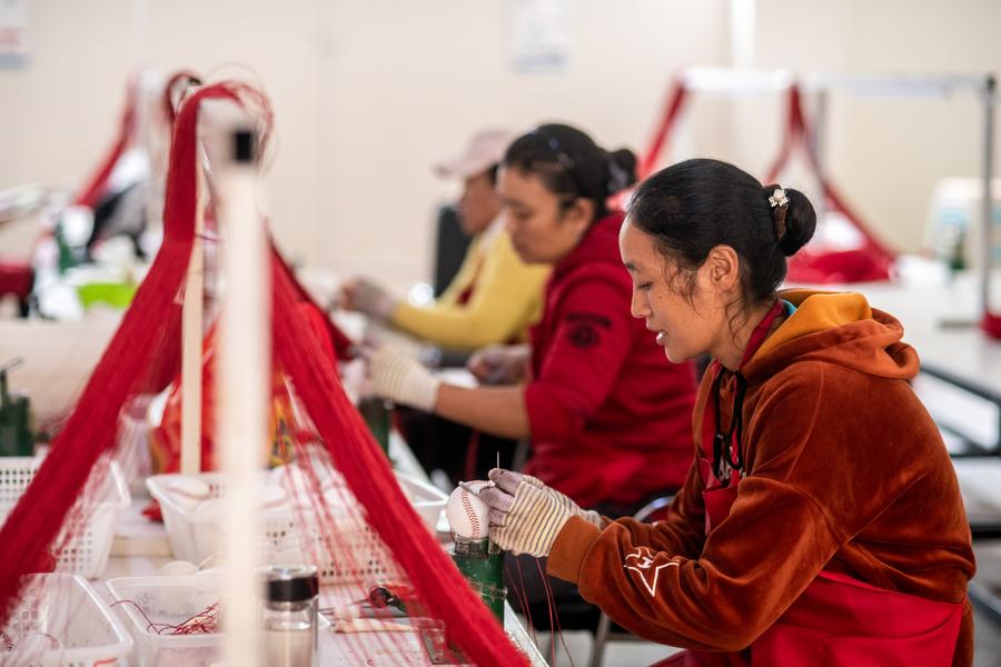 Women work at a poverty relief workshop of a relocation site in Fugong County of Lisu Autonomous Prefecture of Nujiang, southwest China's Yunnan Province, November 2, 2020. /Xinhua