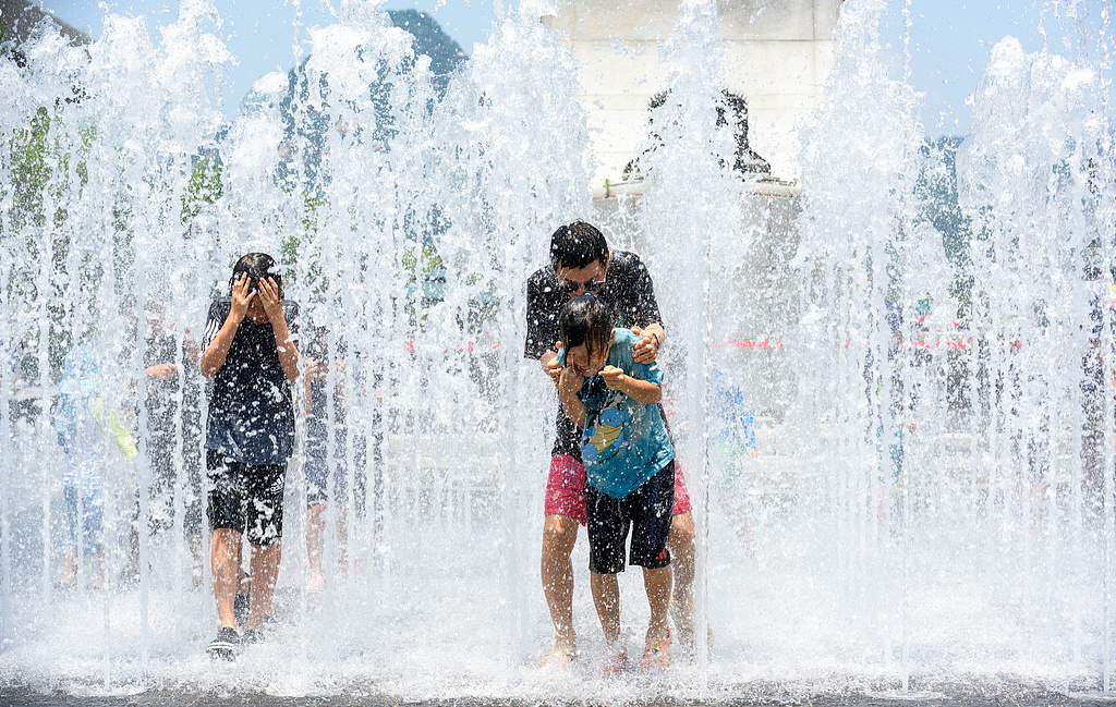 Children play in water at a fountain on a high-temperature afternoon in Gwanghwamun Square, Seoul, South Korea, June 22, 2025. /CFP