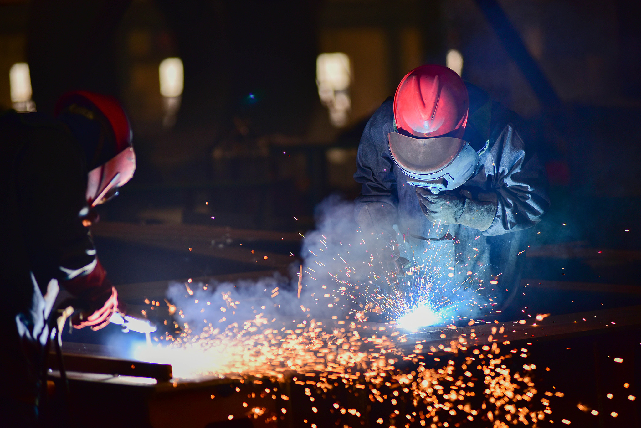 Workers welding components at a wind power equipment manufacturing company in Shandong Province, China, Mar 17, 2025./ VCG