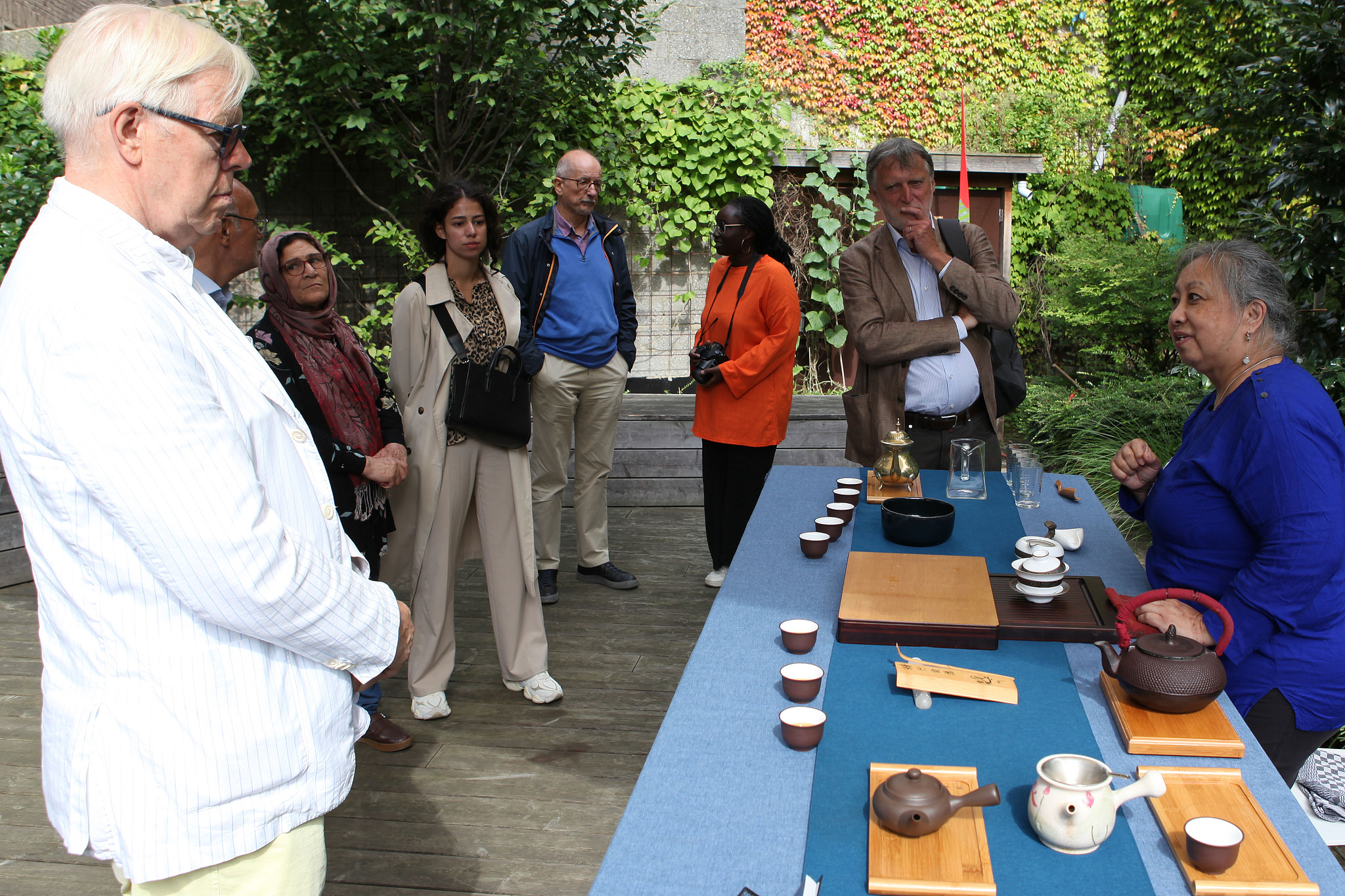 A woman introduces Chinese tea culture to participants at the second 