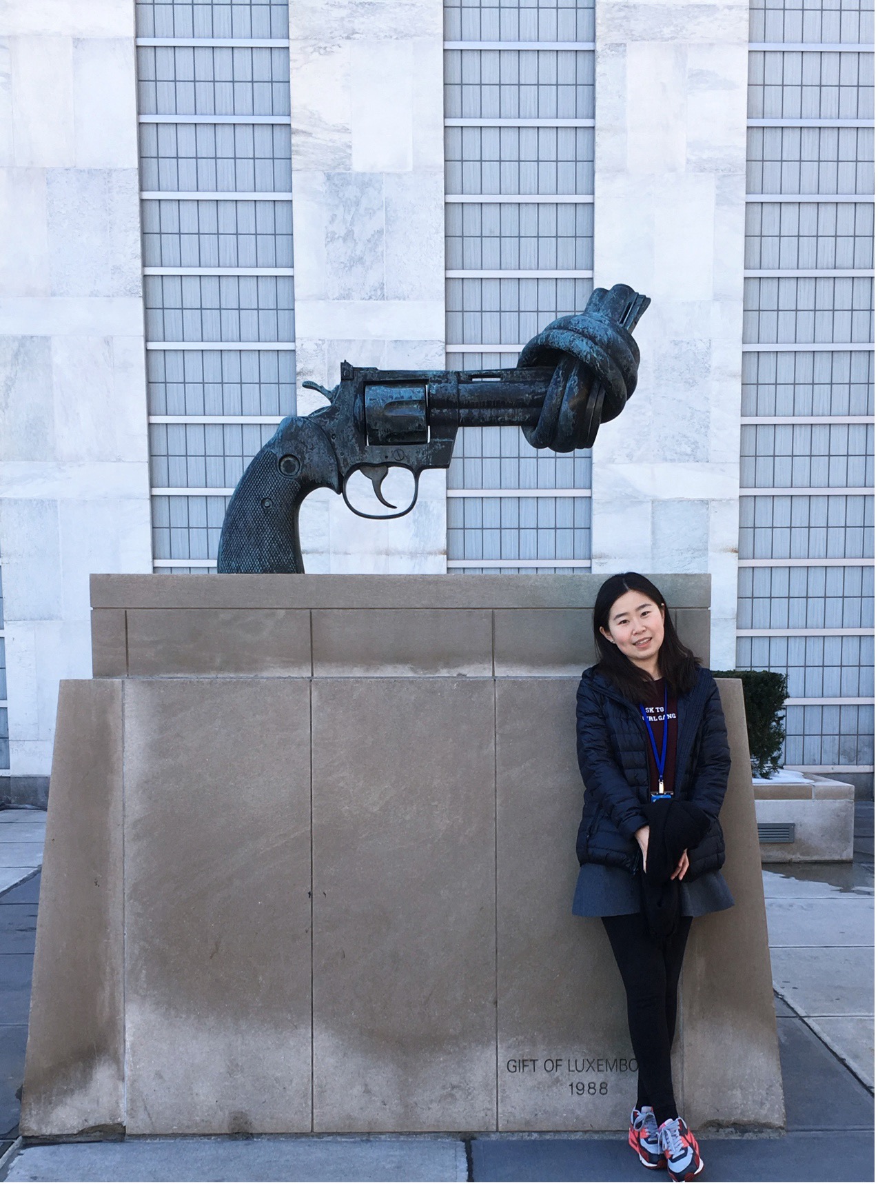 CGTN's Zhao Nan is seen in front of the statue displayed in front of the United Nations (UN) headquarters in New York City. 