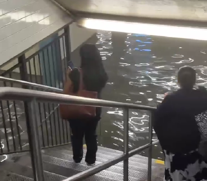 A screenshot from a video shows people stranded at a flooded subway station in Manhattan, New York, July 14, 2025. /China Media Group