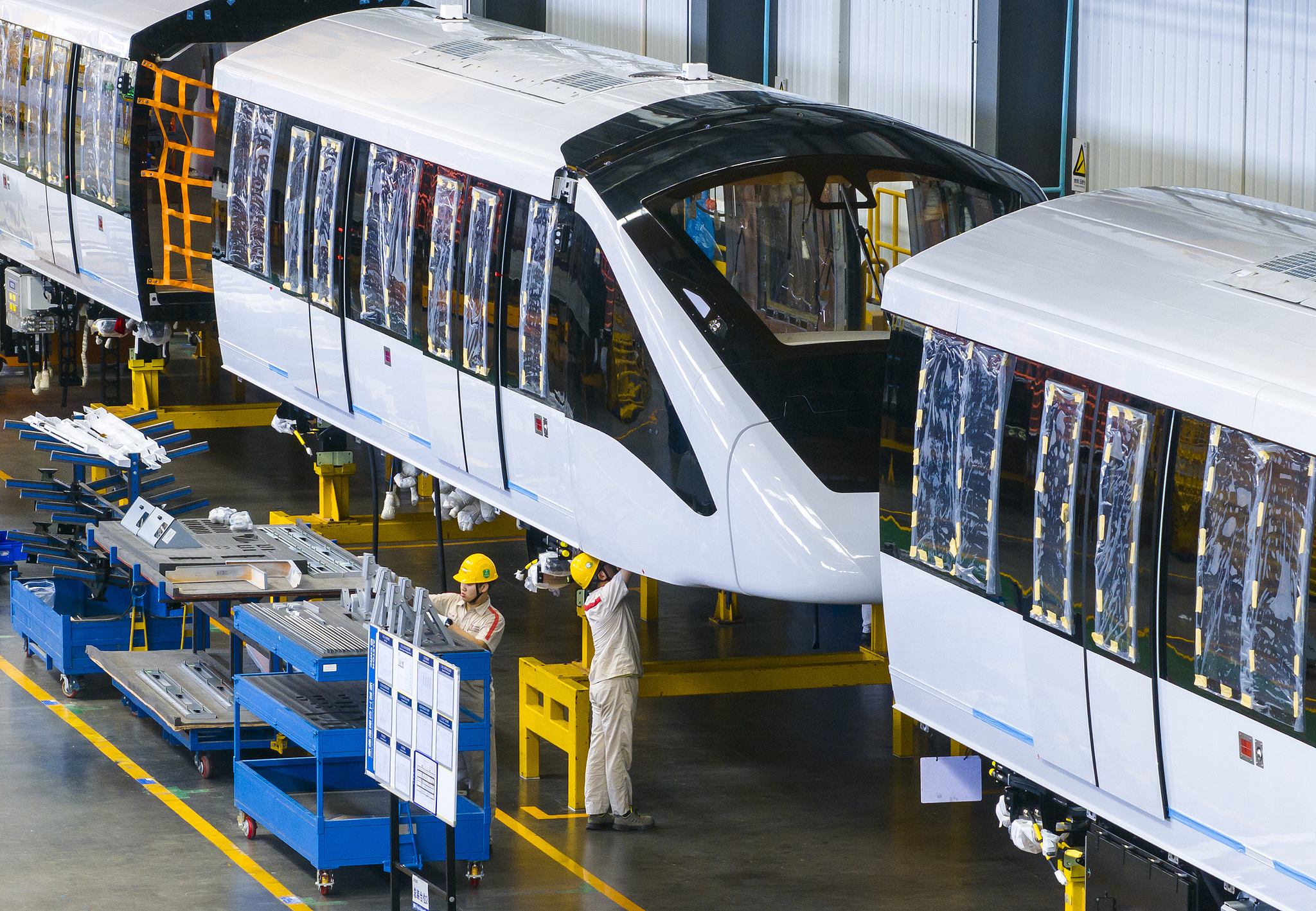 Workers assembling driverless rail trains in Wuhu, east China's Anhui Province, July 17, 2025. /VCG