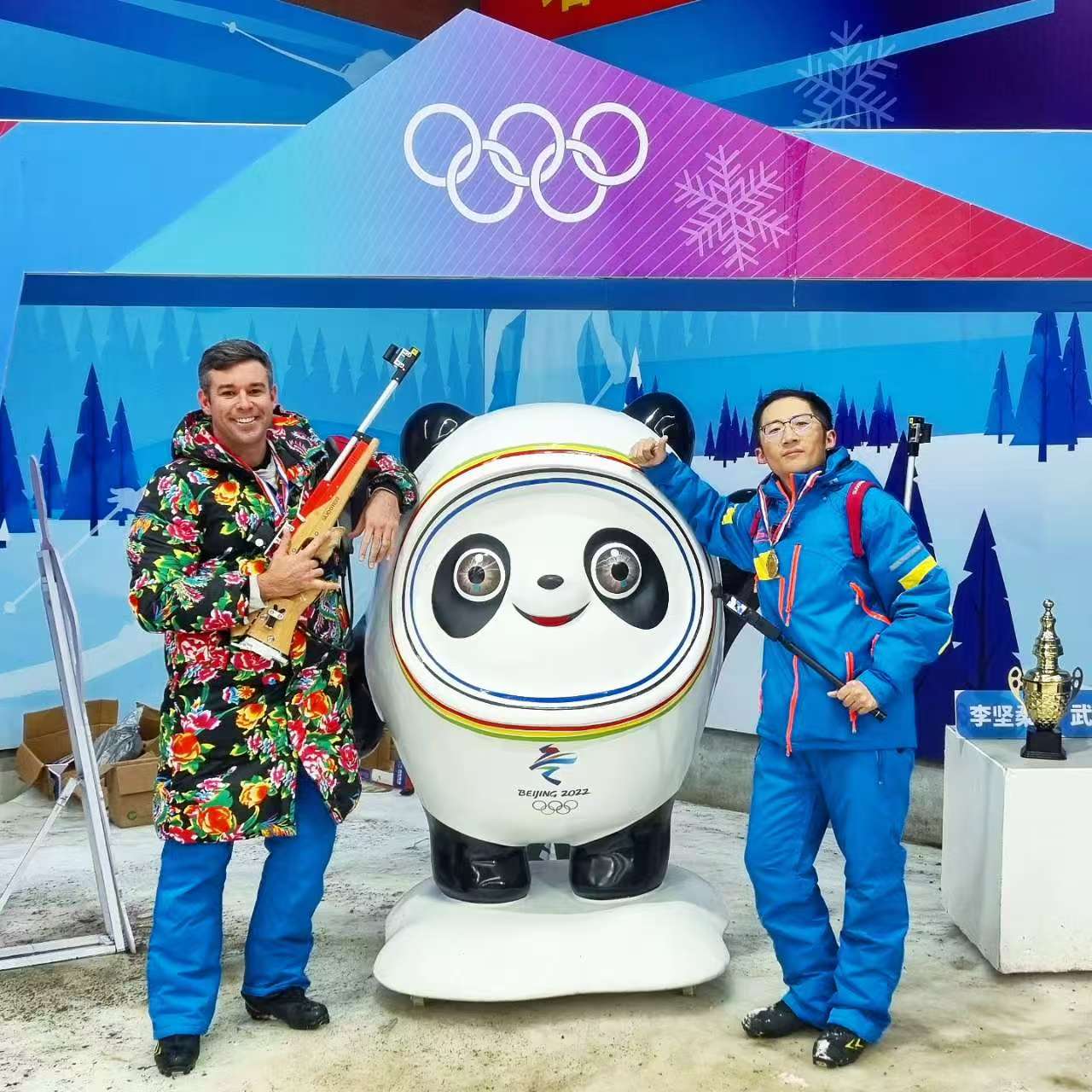 Humphries poses with Bing Dwen Dwen, mascot of the 2022 Beijing Winter Olympics, during the 9th Asian Winter Games in Harbin, Heilongjiang Province, China, February 2025. /CGTN