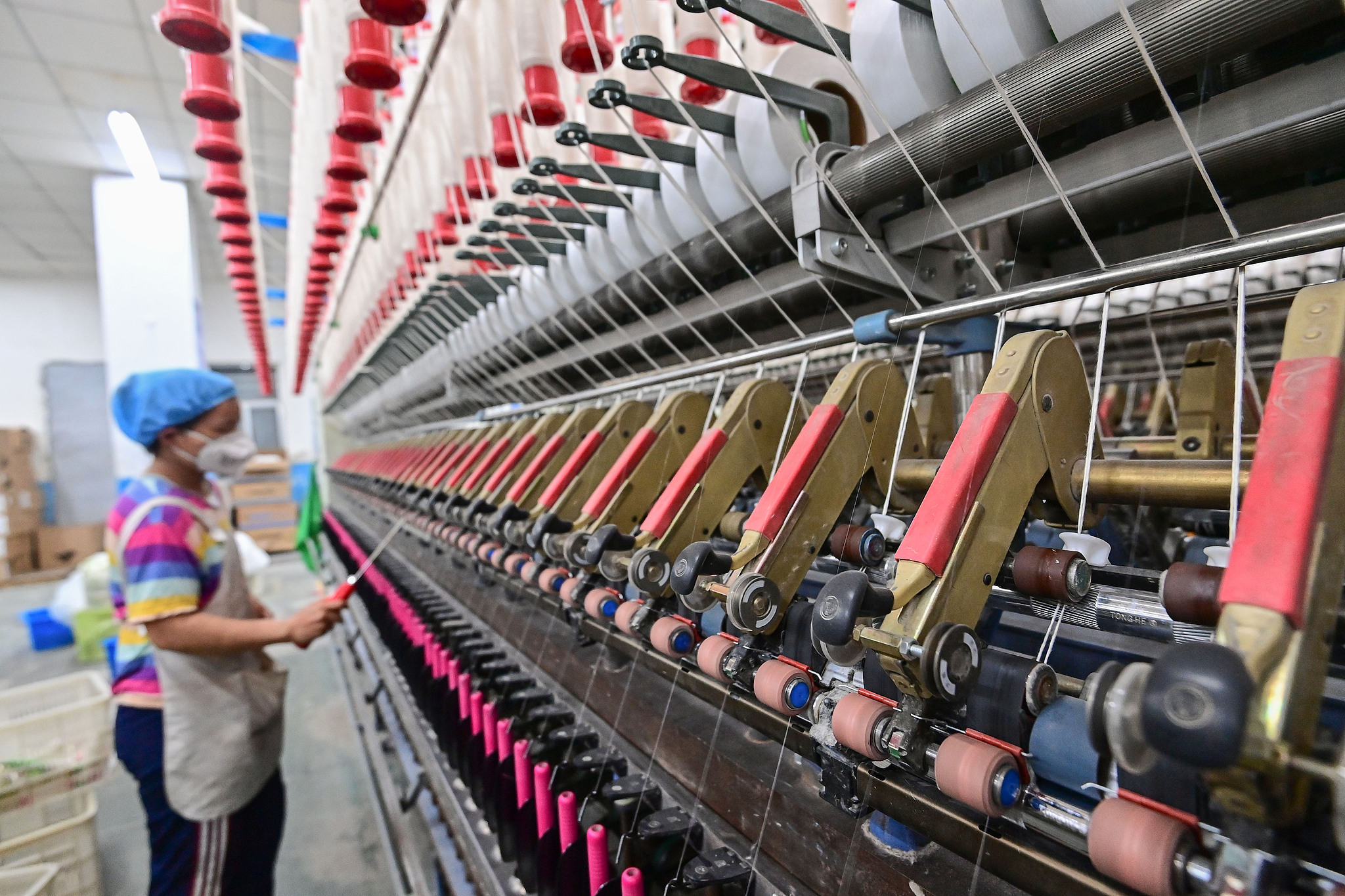 Spinners work on a production line at the Qingzhou Kaiyuan Textile Co., Ltd. in Shandong Province, China, May 10, 2025. /VCG