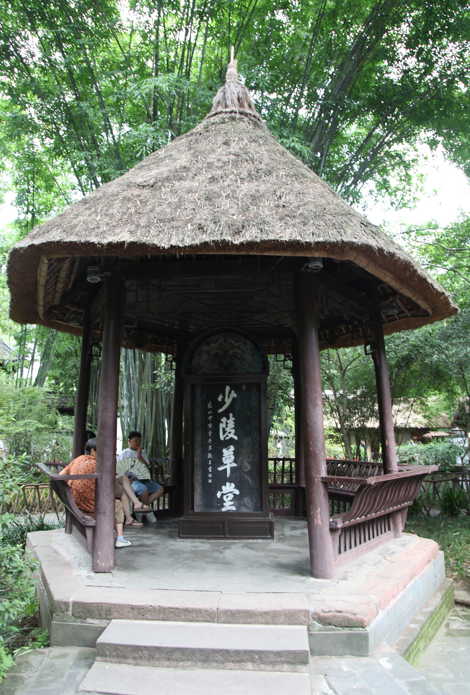 Visitors take a rest at a pavilion at the Chengdu Du Fu Thatched Cottage Museum in Sichuan Province. /CGTN