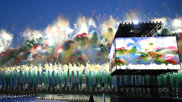 Performers (L) look on as fireworks explode during the opening ceremony of the 2025 World Games at the Tianfu International Convention Center in Chengdu, southwest China's Sichuan Province, August 7, 2025. /VCG