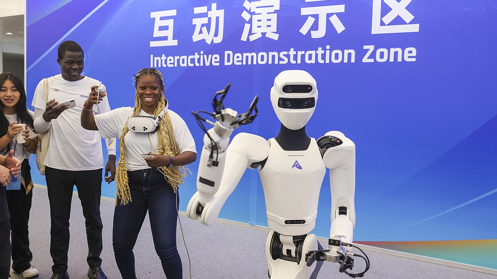Visitors interact with a humanoid robot at the World Robot Conference, Beijing, China, August 8, 2025. /VCG