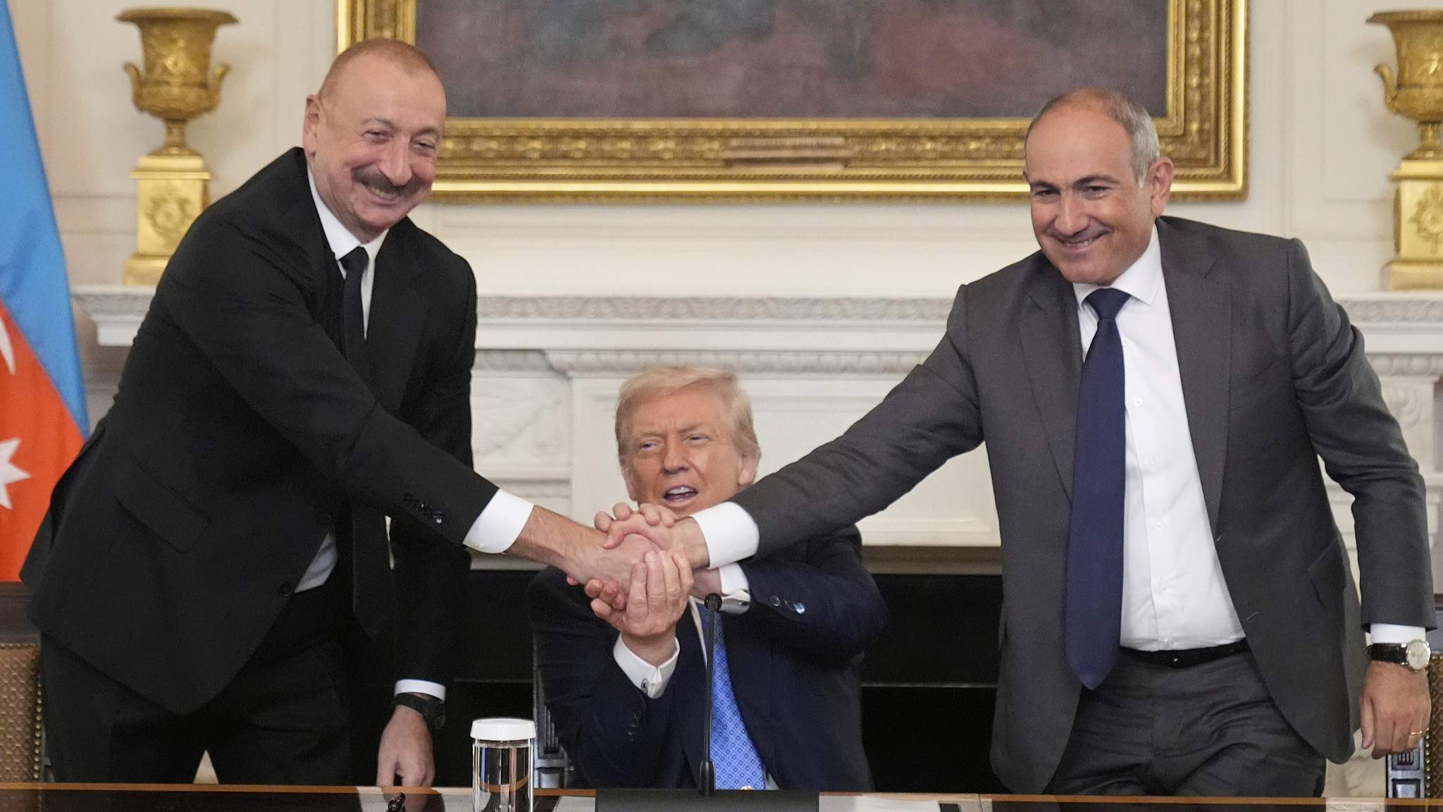 U.S. President Donald Trump (C) shakes hands with Armenian Prime Minister Nikol Pashinyan (R) and Azerbaijan President Ilham Aliyev during a trilateral signing ceremony in the State Dining Room of the White House, in Washington, D.C., U.S., August 8, 2025. /VCG