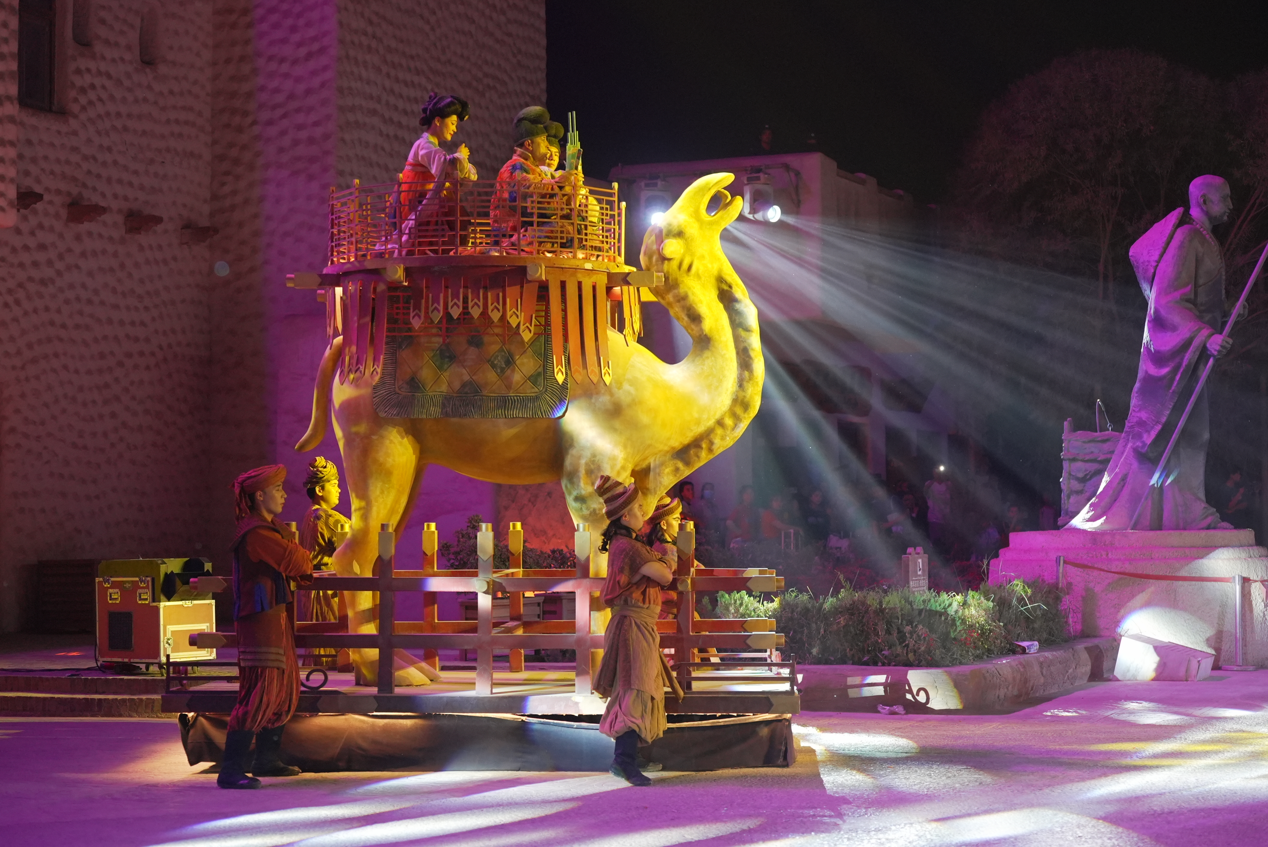 In a Yotkan Ancient City performance, a giant camel becomes a living symbol of the Silk Road, illuminated in light and shadow. 