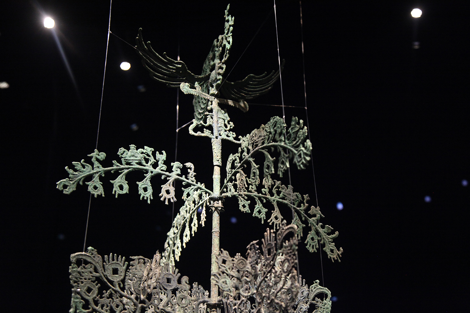 Coin-shaped ornaments are seen on the branches and leaves of a bronze tree on display at the Sanxingdui Museum in Sichuan Province. /CGTN