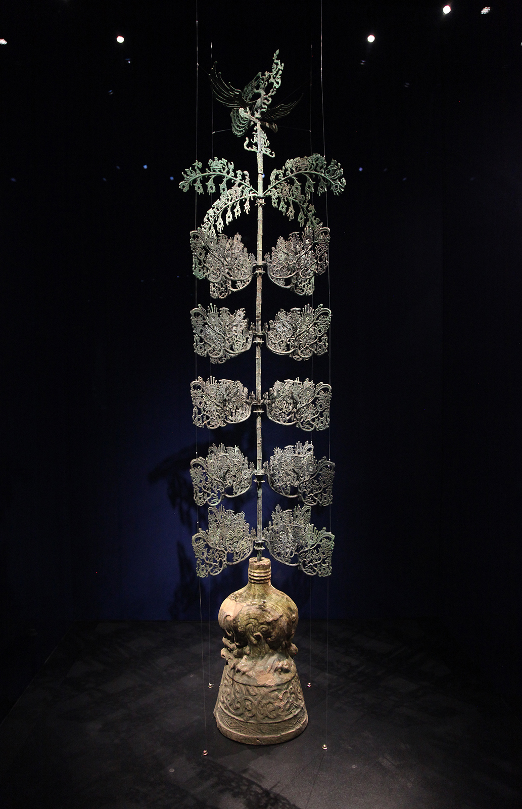 A bronze tree adorned with coin-shaped ornaments on its branches and leaves is seen on display at the Sanxingdui Museum in Sichuan Province. /CGTN