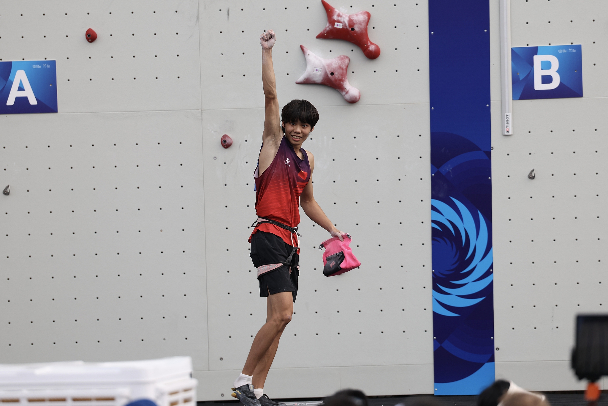 Chu Shouhong of China raises his fist in celebration after winning the men's sport climbing speed final at the 2025 Chengdu World Games in Chengdu, southwest China's Sichuan Province, August 14, 2025. /VCG