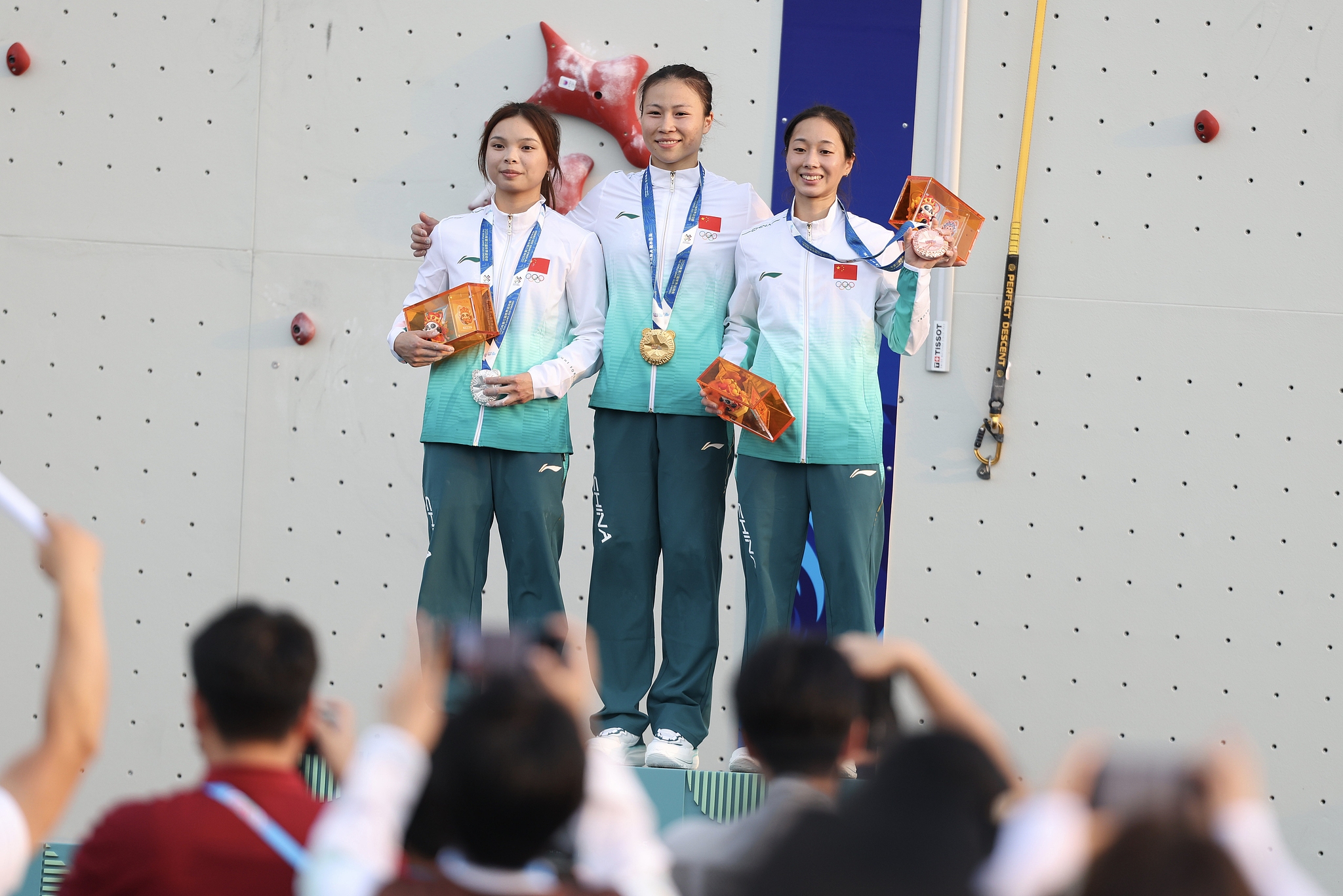 L-R: Silver medalist Qin Yumei, gold medalist Deng Lijuan, and bronze medalist Zhou Yafei of China celebrate on the podium after the women's sport climbing speed final at the 2025 Chengdu World Games in Chengdu, southwest China's Sichuan Province, August 14, 2025. /VCG