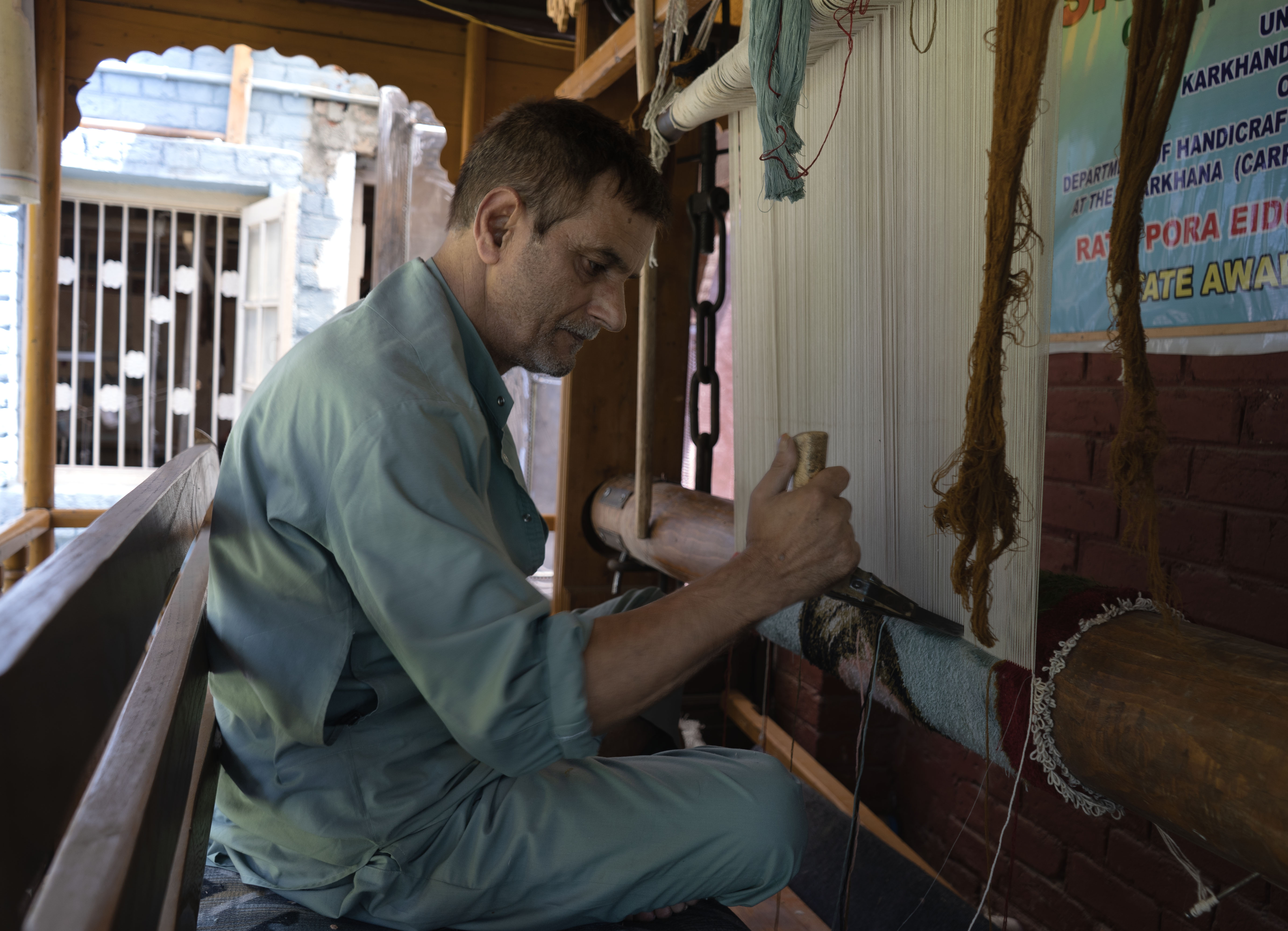 Veteran carpet weaver Manzoor Ahmad Sofi at his home in Srinagar, Indian-administered Kashmir. He has been in the trade for nearly 50 years but fears new U.S. tariffs will affect the centuries-old handicrafts industry. August 5, 2025. 