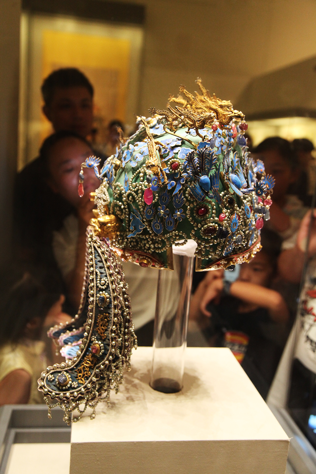 Visitors admire the Phoenix Coronet for Empress Xiaoduan on display at the National Museum of China in Beijing. /CGTN