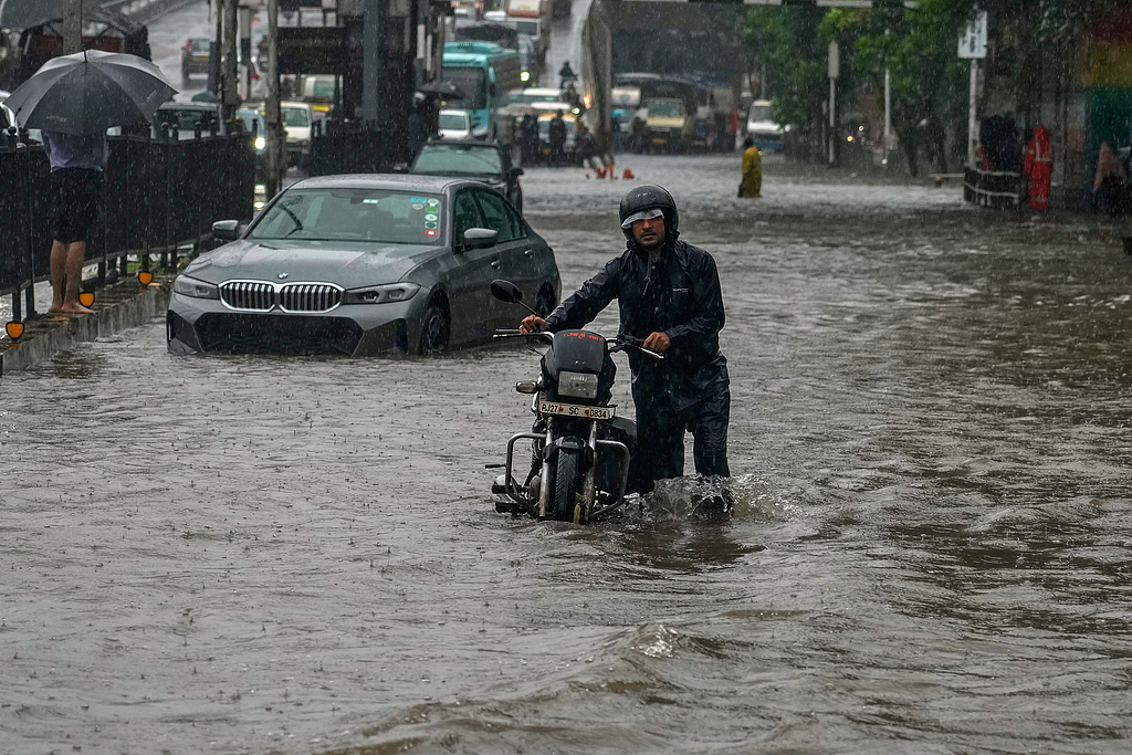Motorists navigate a waterlogged street following heavy rains in Mumbai, India, August 19, 2025. /CFP