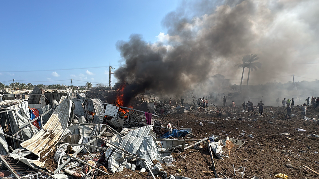 Palestinian Civil Defense teams and civilians respond to a massive fire following an Israeli air strike in Deir al-Balah city, Gaza, August 21, 2025. /VCG