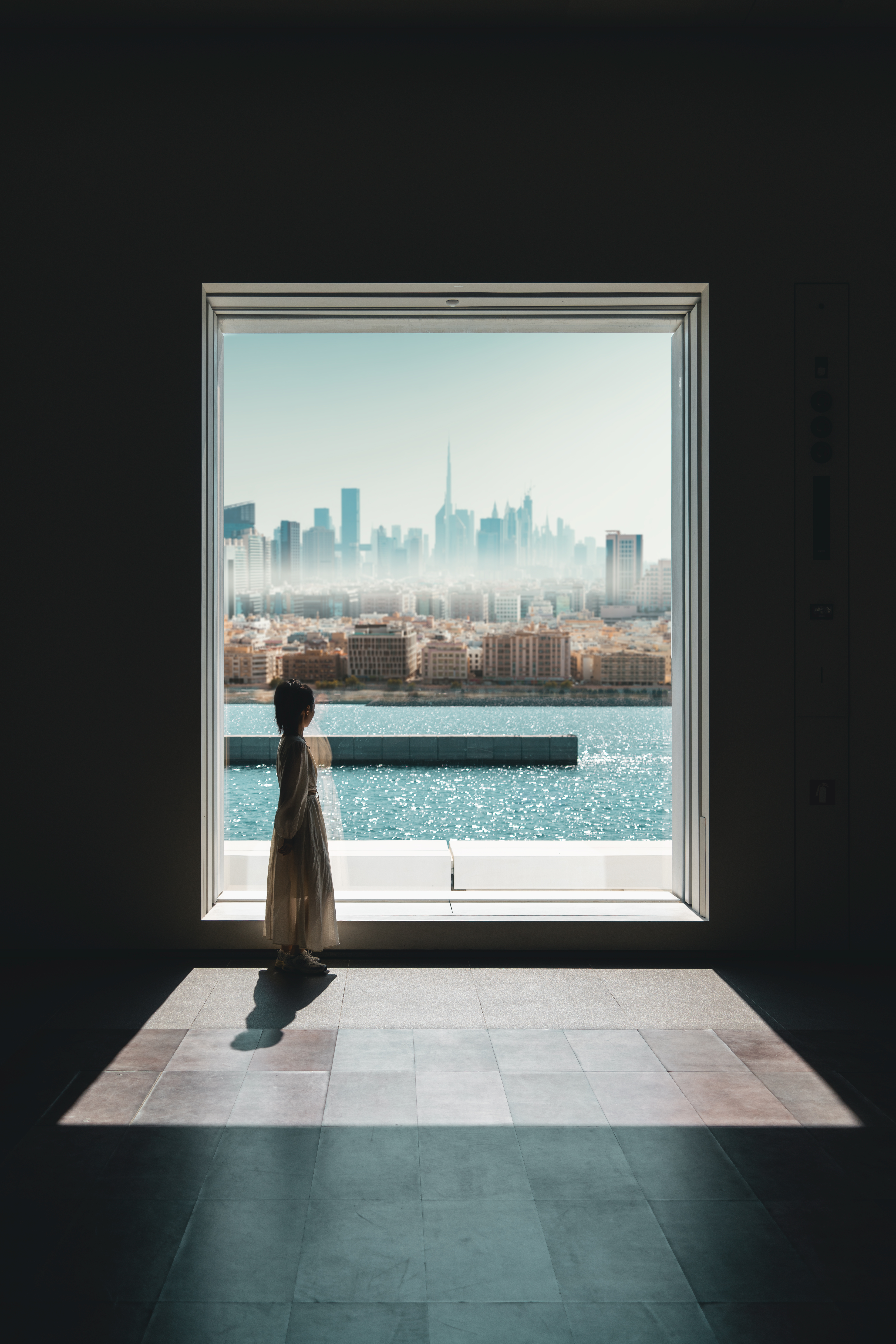 Inception: The window lattice frames the blending of the Dubai skyline and the sea. While the city is climbing upward, it also puts the protection of the blue into action – by establishing marine protected areas, promoting sustainable fisheries, and restoring coastal ecosystems – allowing the brilliance of modern architecture to shine in harmony with the natural beauty of the ocean. What the girl in the picture is gazing at is not just the meeting of the sea and sky, but also a microcosm of humanity's respect for nature and peaceful coexistence with the ocean. Her silhouette seems to silently tell us that only by maintaining a sense of guardianship on the journey toward prosperity and development can the blue expanse continue to thrive. /Yu Yue