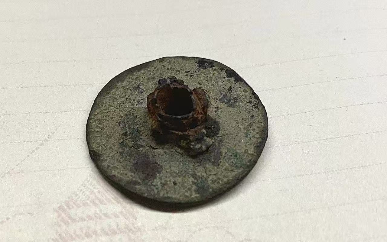 A Shanghai Civilian Women and Children Hospital badge pierced by a bullet.